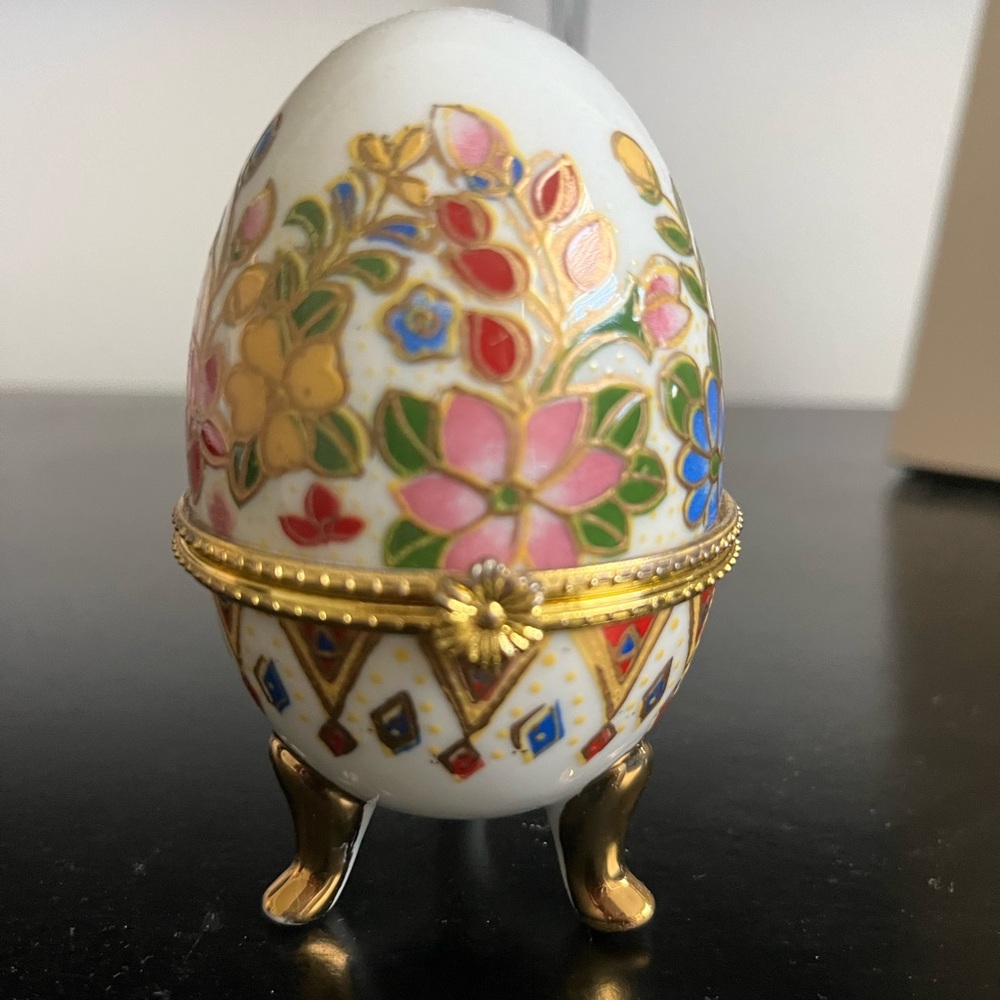 Very beautiful flower designed porcelain egg shaped jewelry box .